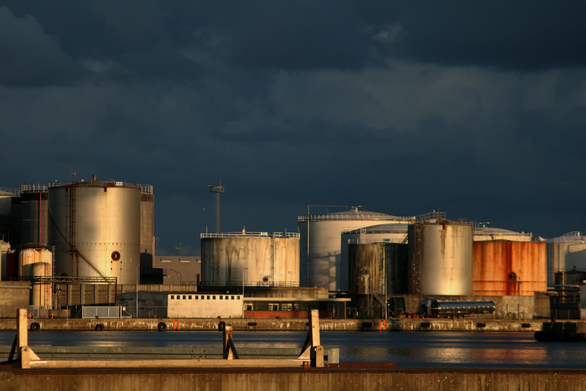 Tank farm under a dramatic sky
